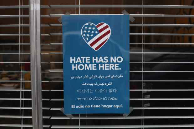 blue and white hate has no home here printed signage
